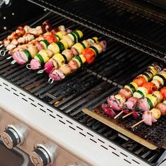 several skewers of food cooking on an outdoor grill