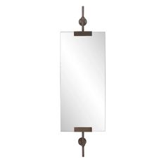 a mirror hanging on the wall next to a hook