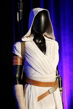 a star wars costume on display in front of a purple curtain