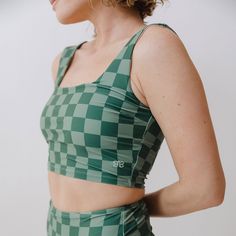 Our Olivia Top + Albion Check = Perfection! This top is ready for adventure with it's wide, supportive straps and built-in shelf bra. Not to mention this gorgeous emerald shade! Yes please! Removable bust cups Fully-lined Checker print 45 UPF Pair with Green Check High-Waisted Bottoms FREE U.S. Standard Shipping! More info hereModel Sophia is 5'6", a size 2, and wears an XS90% NYLON - 10% SPANDEXWash cold and lay flat to dry Green Yoga Sports Bra With Adjustable Straps, Green Sports Bra With Adjustable Straps For Yoga, Green Functional Sports Bra With Adjustable Straps, Functional Green Sleeveless Sports Bra, Green Bra Friendly Athleisure Tank Top, Green Bra-friendly Athleisure Tank Top, Green Athleisure Top, Bra Friendly, Green Athleisure Tank Top, Bra Friendly, Green Athleisure Tank Top Bra Friendly