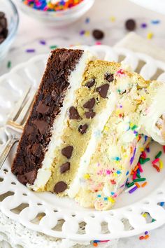 a slice of cake with white frosting and sprinkles on a plate