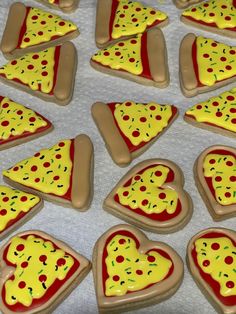 there are many heart shaped pizza cookies on the table