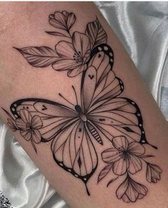 a black and white butterfly tattoo on the leg