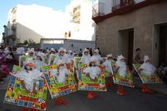 a group of people that are standing in the street with some decorations on their heads