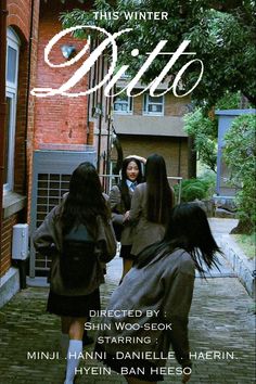 two girls are walking down the street in front of a building and one girl is holding her hand out