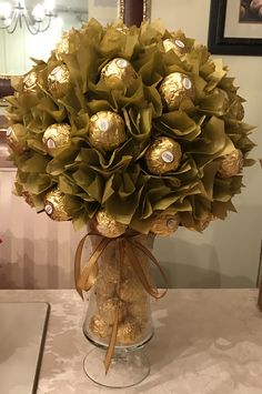 a vase filled with lots of chocolates on top of a table