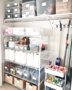 an organized pantry with plastic bins and shelves filled with food, cleaning supplies and other items