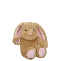 a brown stuffed animal with pink ears