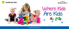 five children sitting on the floor playing with blocks