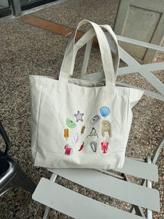 LIMITED EDITION- ONLY 8 AVAILABLE The summer tote or beach bag of your dreams is HERE! Icons of el Verano that bring summer vibes to any season☀️ 100% Cotton/ Multicolor design Embroidered with love by JZD in Brownsville, TX Pocket inside Measurements Tote bag: 14" x 14" Depth: 5.5" Handles: 11" Circle Outline, Summer Tote, Bag Icon, Loungewear Sets, Custom Embroidery, Custom Boxes, Corporate Gifts, Bridal Accessories, Beach Bag