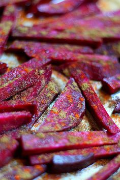 beets that have been chopped up on a cutting board with yellow and red flecks