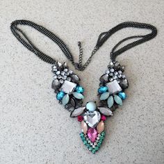 a necklace with many different colored stones on it