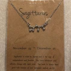 a necklace with the words sagittuus written on it and two butterflies attached to it