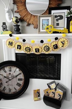 a mantle with a clock and decorations on it