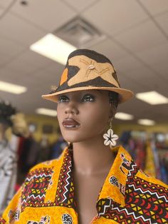 This African Print Fedora is beautiful and unisex. The fedora looks great for the summer with a touch of cowrie shell. Comfortable fits small to med size heads.Don't delay order yours today. Brown Brimmed Costume Hats For Beach, Brown Brimmed Costume Hats And Headpieces For Beach, Traditional Flat Brim Fedora For Summer, Traditional Summer Fedora With Flat Brim, Summer Brimmed Hat As A Gift, Summer Brimmed Hat As Gift, Handmade Brown Mini Hats For The Beach, Handmade Brown Mini Hats For Beach, Unique Fedora With Short Brim For The Beach