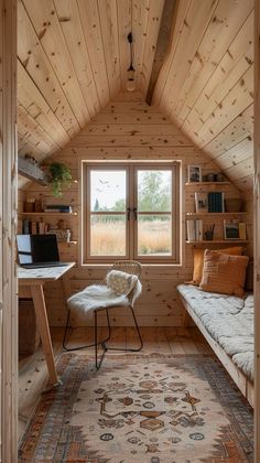 a room with a bed, desk and window in it's attic style home