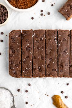 chocolate brownies cut into squares on top of white paper