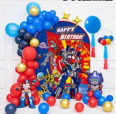 a birthday party scene with balloons, decorations and an image of a robot on the wall