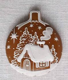 a christmas ornament with a church and trees on it