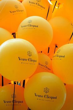 many yellow balloons with the words veuve clouquet on them