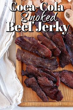 there is a wooden cutting board with steak on it and the words, how to cook coal - cola smoked beef jerry