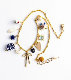 CHARM NECKLACE, Bow Charm Necklace, Heart Charm Necklace, Lapis Necklace, Charms, Gold Necklace, Delicate Charm Necklace, Ceramic Charms - Etsy Whimsical Gold Charm Necklaces, Whimsical Gold Pendant Charm Necklace, Elegant Gold-tone Necklaces With Dangling Charms, Yellow Gold Necklace With Dangling Charms Pendant, Yellow Gold Jewelry With Heart Pendant And Dangling Charms, Yellow Gold Pendant Necklace With Dangling Charms, Whimsical Gold Charm Necklaces With Lobster Clasp, Whimsical Gold Necklaces With Lobster Clasp, Gold Necklaces With Dangling Charms For Gifts