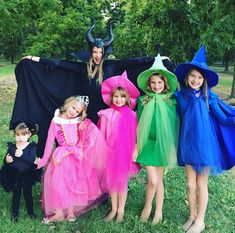 several children in costumes posing for a photo