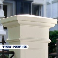 a tall white pillar sitting in front of a building