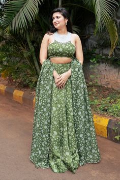 Olive green attached cancan lehenga with all over floral print. Paired with a padded blouse with matching print and hand embroidered with pearls, mirrors and glass beads and dupatta with matching print and sequin embroidered scallop border. - Aza Fashions Green Chanderi Lehenga With Unstitched Blouse, Green Palazzo Set With Unstitched Blouse For Reception, Green Palazzo Set With Unstitched Blouse For Wedding, Green Lehenga With Tilla For Reception, Sleeveless Green Georgette Choli, Green Sleeveless Designer Choli, Sleeveless Green Anarkali Choli, Green Sleeveless Georgette Lehenga, Green Palazzo Set With Unstitched Blouse For Festivals