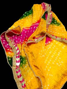 Art Silk  Multicolor Tie and Die Bandhani Dupatta|Bandhej Dupatta|Multicolor Dupatta Wrap|Crushed Dupatta|Ethnic dupatta|Designer Scarf Washing Instructions - Do not Machine Wash. Do Not Iron. Good for gifting. Do not worry what to gift. This is better option to gift. Material - Crushed Silk.  Dupatta length X Breadth: 2.04  X 0.98 mts. Color:  Multicolour   Tassels: 2 Comfortable & Durable & Trendy Look. Weight: 135 gm Embroidered designer border with pearl lace and gotta. This dupatta can be p Multicolor Dupatta With Cutdana For Puja, Festive Yellow Traditional Wear With Bandhani Print, Traditional Multicolor Sharara With Sheer Dupatta, Yellow Bandhani Print Art Silk Traditional Wear, Multicolor Bandhani Print Choli For Puja, Yellow Bandhani Print Traditional Wear In Art Silk, Yellow Art Silk Traditional Wear With Bandhani Print, Multicolor Dupatta For Puja And Eid, Yellow Gota Work Dupatta For Puja