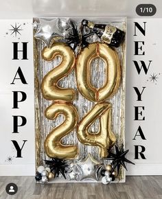 a happy new year sign with balloons and confetti in the shape of numbers