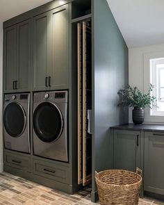 a washer and dryer in a laundry room next to cabinets with doors open