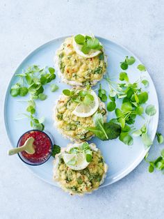 three crab cakes on a plate with garnish