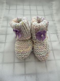 These hand-knitted baby booties are a must-have for any parent looking for a unique and personalized touch to their baby's wardrobe. The hand-knitted design adds a special touch to the booties, making them stand out from mass-produced items. The hand-knitted process also ensures that each pair of booties is unique, making them a one-of-a-kind addition to your baby's wardrobe. The hand-knitted baby booties are not only stylish but also comfortable and practical. The soft and cozy material ensures that your baby's feet stay warm and comfortable, while the non-slip design provides added safety and stability for your little one. The booties are also easy to put on and take off, making them a convenient choice for parents on the go. These hand-knitted baby booties are perfect for any occasion, Cozy Knitted Booties With Round Toe, White Booties As Winter Gift, White Winter Booties As A Gift, White Winter Booties As Gift, Cute Yarn Booties As A Gift, Cute Yarn Booties As Gift, White Hand Knitted Booties As Gift, Handmade Casual Booties As Gift, Cute Handmade Pink Booties