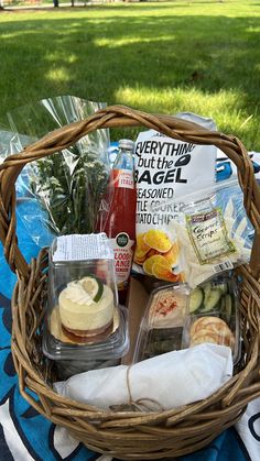 a picnic basket filled with food and condiments