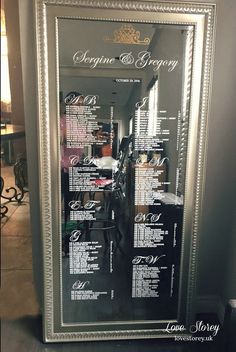 the wedding seating chart is displayed in a silver framed frame with black lettering on it