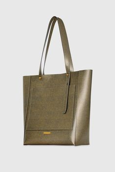 The perfect tote for carrying your everyday essentials. Our new Stevie North South Tote fits your laptop and so much more. Style# HF24TGFTNS-GOLD 100% Genuine Leather Antique Brass Hardware 11. 5" W X 13. 5" H X 5. 25" D Handle Drop: 11" Magnetic Snap Closure Interior Slip Pocket Exterior Slip Pocket Unlined Imported The photos featuring a model are for size reference only. Actual color and material may vary from what is depicted. | Rebecca Minkoff Stevie North South Tote Bag In Gold Modern Gold Shoulder Bag For Work, Gold Double Handle Shoulder Bag For Work, Gold Rectangular Bags For Work, Gold Rectangular Workwear Bags, Rectangular Gold Bags For Work, Modern Gold Bags For Everyday Use, Modern Gold Bag For Work, Gold Double Handle Work Bags, Everyday Rectangular Shoulder Bag With Magnetic Closure