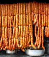 several rows of cooked carrots are stacked on top of each other in metal pans