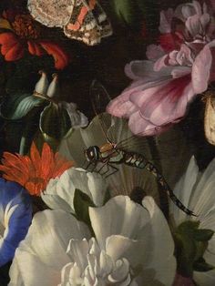 a close up of flowers with a dragonfly in the middle and another insect on it