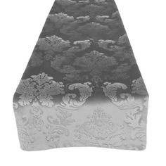 an ironing board covered in black and white damask fabric with floral designs on it