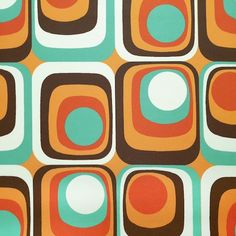 an orange, green and brown pattern with white circles on it's surface is shown