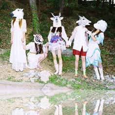 four girls dressed up in costumes standing next to each other