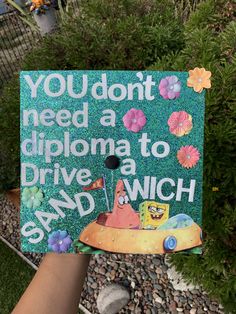 a hand holding up a sign that says you don't need a diploma to drive a