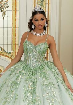 Prepare to be dazzled in this glittering Vizcaya quinceaera ball gown (style 89472). Stunning patterned sequins cascade down the sheer bodice with corset boning, creating a shimmering and figure-flattering silhouette. Diamant and crystal beading add a touch of bling, accenting the luxurious sparkle tulle that shimmers with every move. The detachable back bow adds a sweet and romantic touch, allowing you to personalize your look. Feeling a bit cool or want to add a touch of coverage? The matching Short Sleeve Bolero, Corset Boning, Pretty Quinceanera Dresses, Quince Dress, Sherri Hill Prom Dresses, Gown Style, Dresses Quinceanera, Ball Gown Skirt, Mori Lee