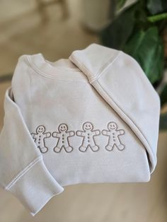 Bundle up in this lineup of adorable gingerbread men sweatshirt. Featuring a lineup of 4 gingerbread men in a brown thread. Great sweatshirt for the holiday baking season. Wake up in the morning, put on your cozy gingerbread men sweatshirt, and get to baking some delicious holiday cookies. These Independent trading sweaters are the coziest ones out there and are the perfect addition to your closet! Gift this to your girlfriends to match up for the winter! Endless options that are perfect for the Christmas Crewneck, Gingerbread Men, Men Sweatshirt, Sweatshirt Christmas, Embroidered Sweatshirt, Christmas Cookie, Holiday Cookies, Holiday Baking, Embroidered Sweatshirts