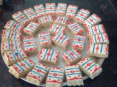 red, white and blue shortbreads are arranged in a circle on a plate