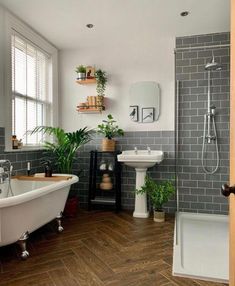 a bathroom with a tub, sink and mirror