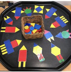 a tray that has some different colored shapes on it and a basket full of them