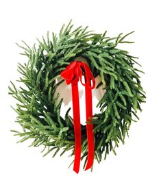 a christmas wreath with red ribbon hanging from it