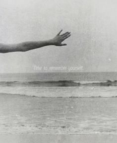 a hand reaching out towards the ocean with an inspirational quote above it that reads time to remember yourself